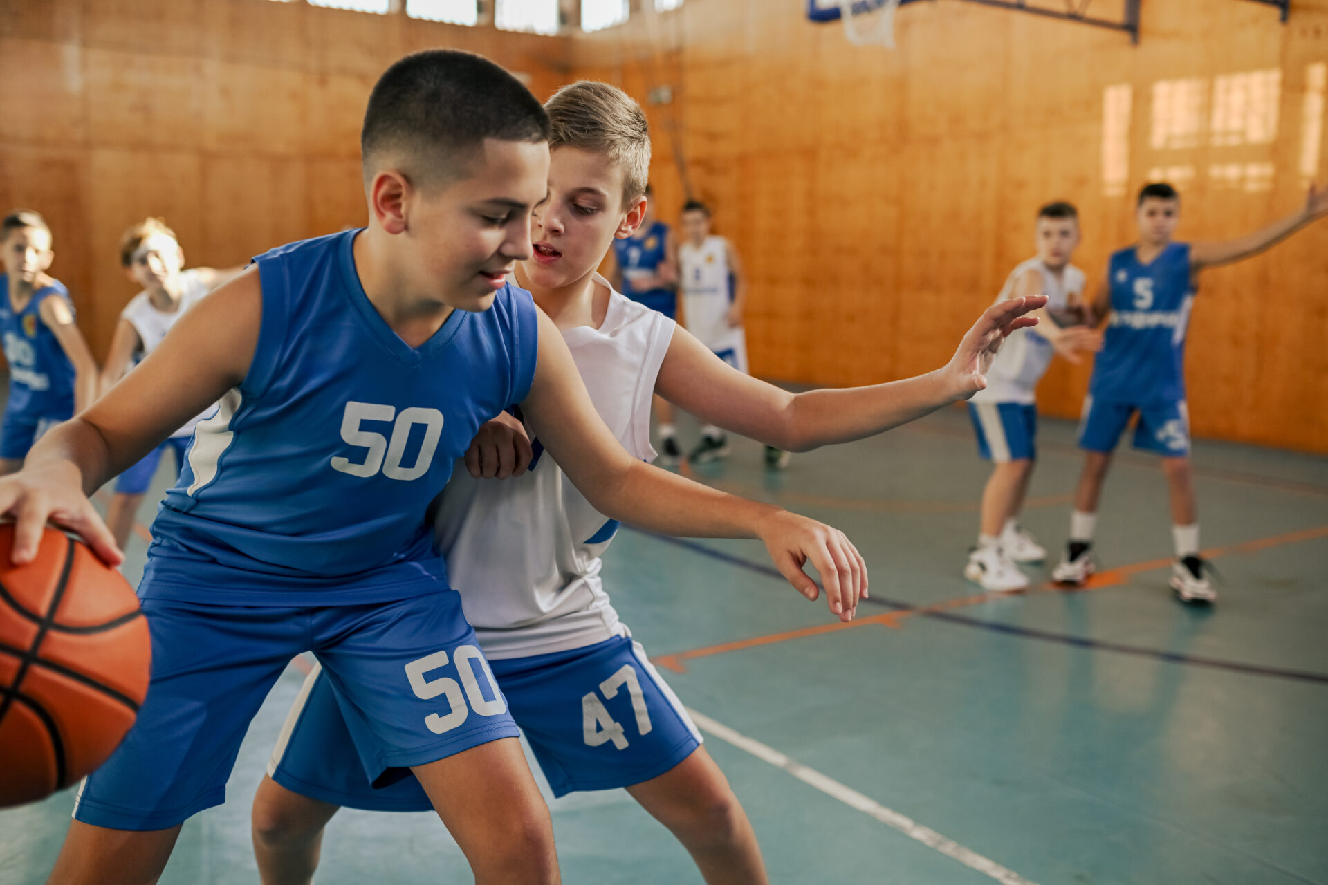 A junior basketball team is practicing game on training.